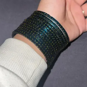 Customer photo: teal glass bangles on wrist
